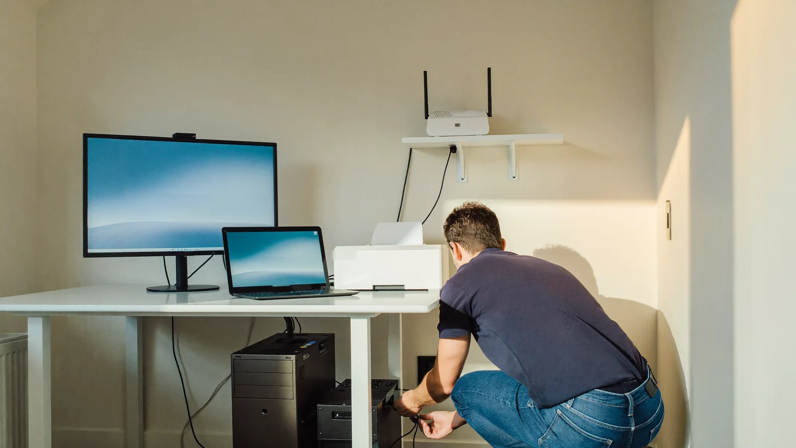 Small business computer support in Las Vegas: technician helping at a small office desk with a PC and printer