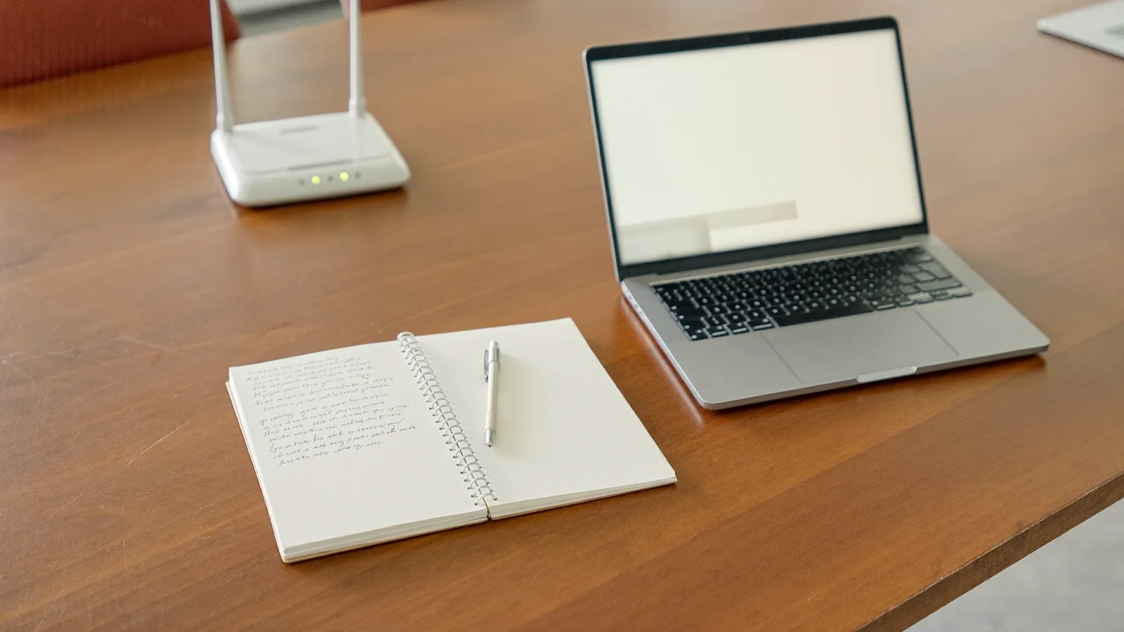 Notepad and laptop on an office desk ready for a technician visit