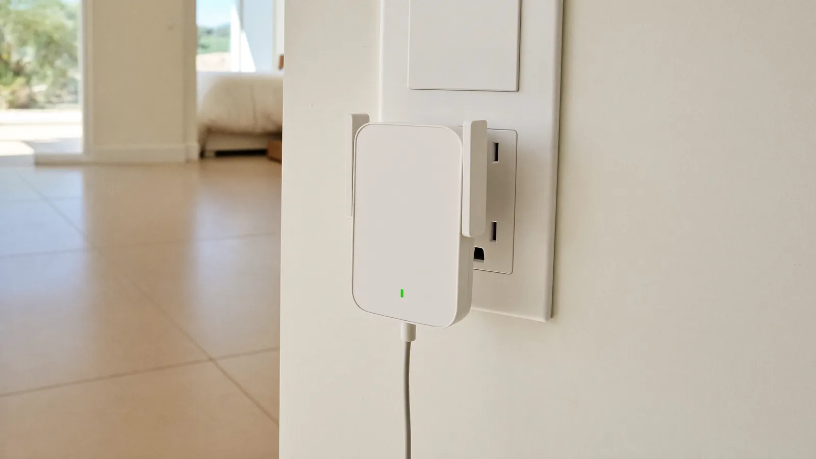 Plug-in WiFi extender in a hallway outlet between the router and a back bedroom